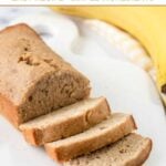 A loaf of homemade banana bread for dogs and a banana next to it.