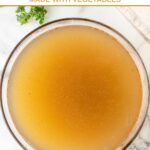 A bowl of homemade beef broth for dogs on a marble surface.