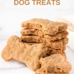 A stack of homemade bone-shaped carrot cake dog treats.