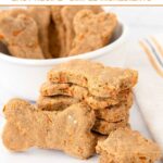 A stack of homemade carrot cake dog treats in a stack and in a bowl behind it.