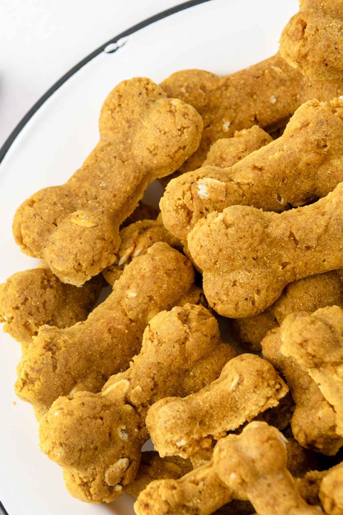Homemade turmeric dog treats that are bone-shaped.