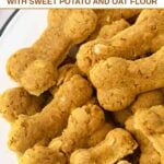 Homemade bone-shaped turmeric dog treats piled in a bowl.