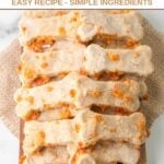 Homemade bone-shaped cheese dog treats piled on a small wood platter.