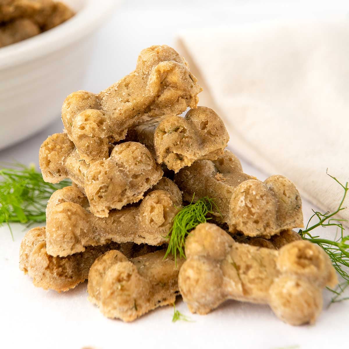 Homemade fennel dog treats and fennel fronds in a pile.