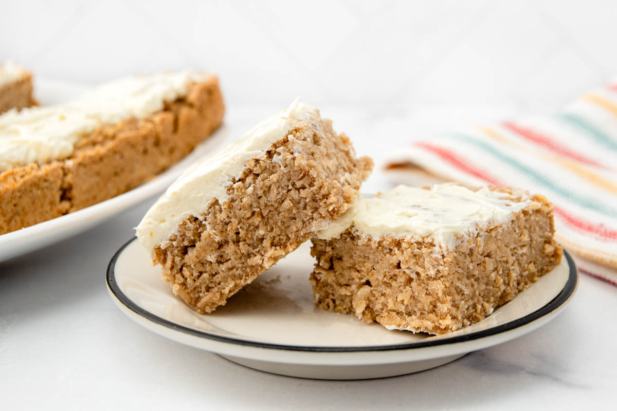 Two slices of applesauce cake for dogs on a plate beside the cake.