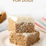 Two slices of applesauce cake for dogs stacked on a small plate.