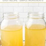 Two jars of homemade bone broth for dogs.
