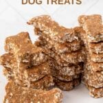 Stacks of bone-shaped homemade brewer's yeast dog treats made with applesauce and oats.