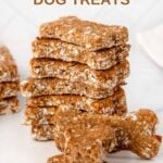 A stack of bone-shaped homemade brewer's yeast dog treats on a marble surface.