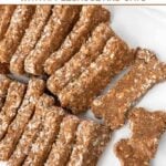 Bone-shaped homemade brewer's yeast dog treats on a marble surface.