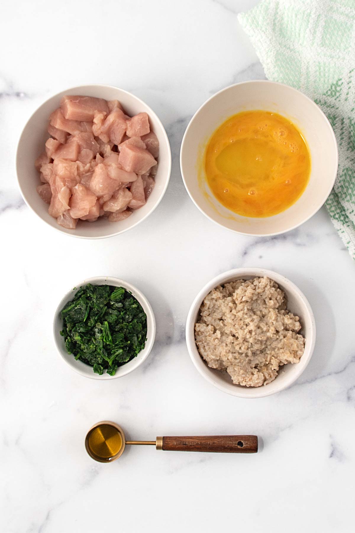 Cubed chicken breast, beaten egg, spinach, oatmeal, and olive oil.