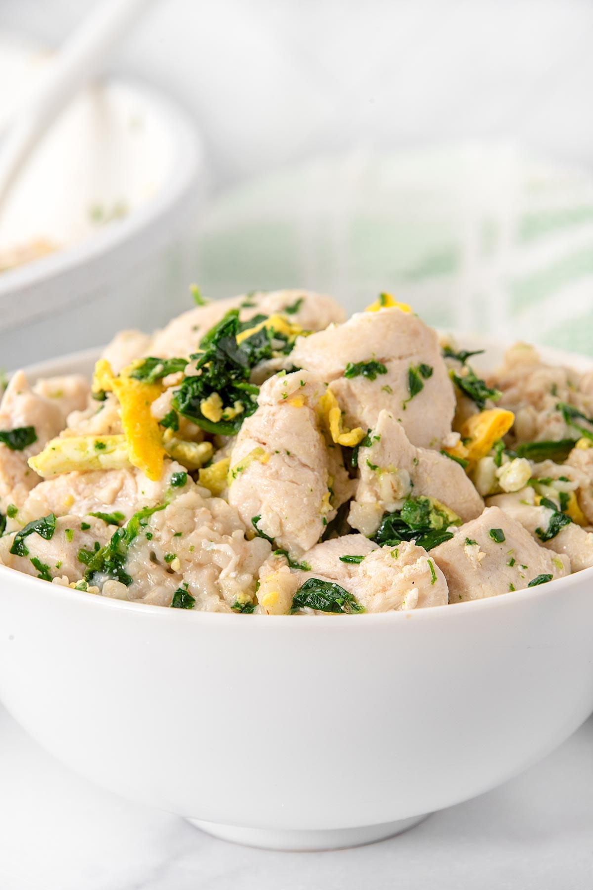 Breakfast bowl with chicken, egg, spinach, and oatmeal.
