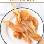 Dehydrated chicken wrapped sweet potato dog treats on a small plate.