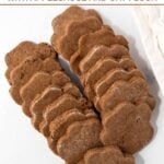 Rows of homemade cricket protein dog treats on a marble surface.