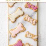 Homemade dog cookies with icing on a marble platter.