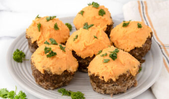 Meatloaf cupcakes with sweet potato frosting for dogs on a plate.