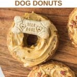 Homemade peanut butter dog donuts topped with peanut butter and a dog biscuit and bacon bits.