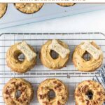 Homemade peanut butter dog donuts in a donuts and an on a wire rack.