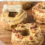 Several homemade peanut butter dog donuts on a round wood platter.