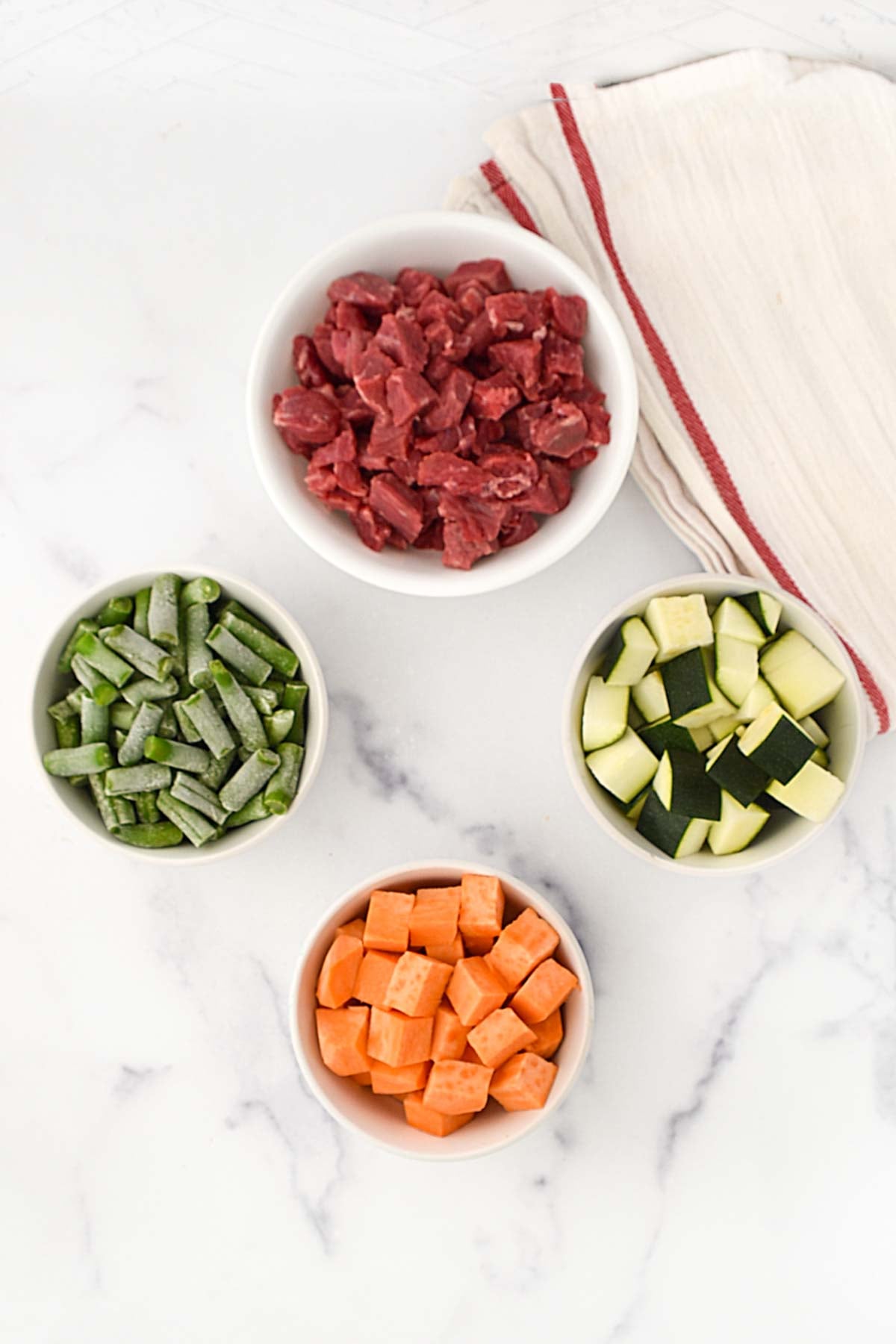 Beef stew meat, green beans, zucchini, and sweet potato.