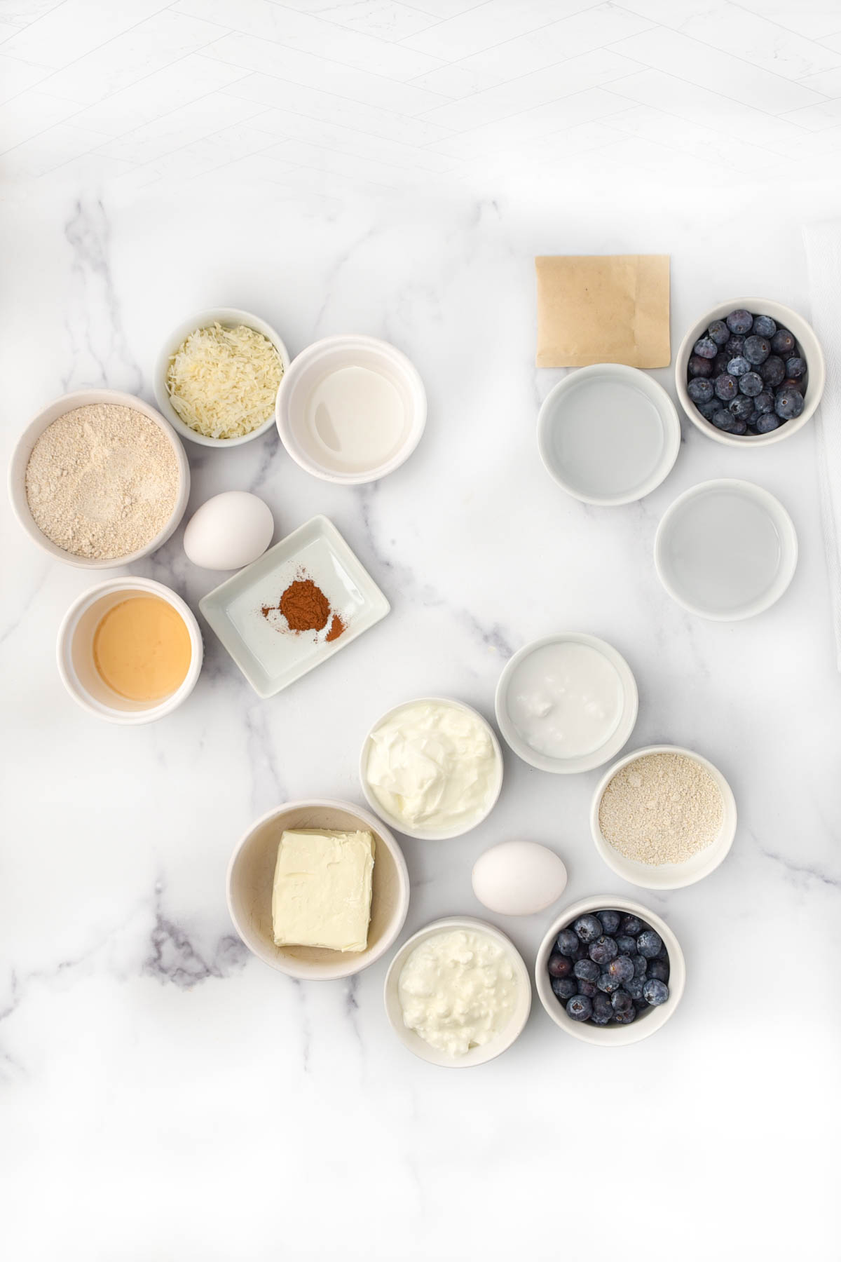 Ingredients to make dog-friendly blueberry cheesecake crust, filling, and topping.