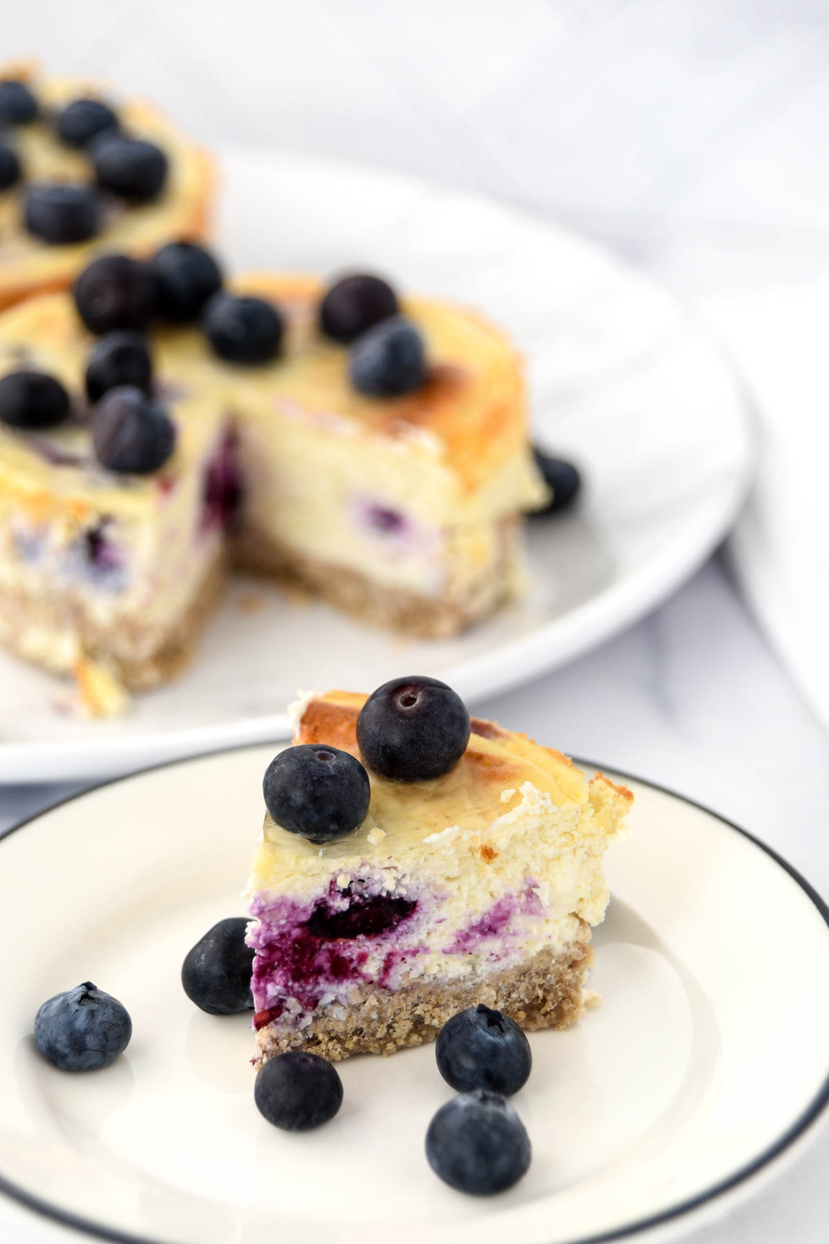 A slice of blueberry cheesecake for dogs in front of the dessert.