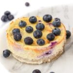 Blueberry cheesecake for dogs topped with fresh blueberries and gelatin glaze.