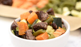 Homemade beef and veggie dog food cooked on a sheet pan in the oven.