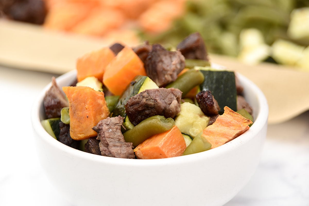 Homemade dog food with beef and vegetables cooked in the oven.