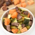 Sheet pan beef and veggie dog food served in a small bowl.