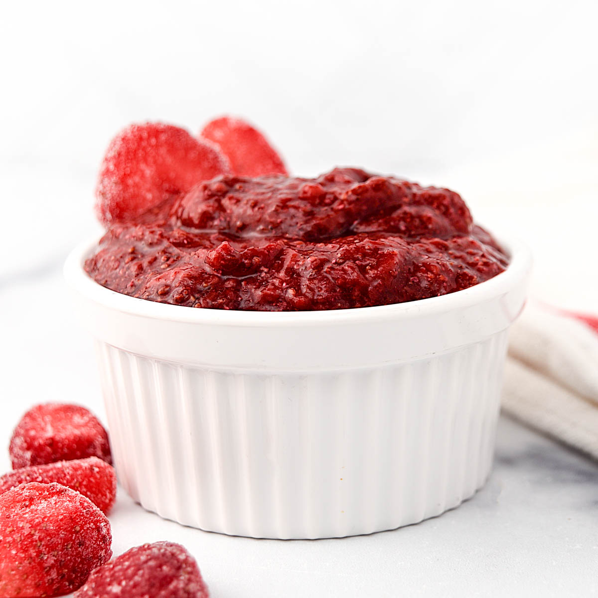 Homemade strawberry jam for dogs in a ramekin.