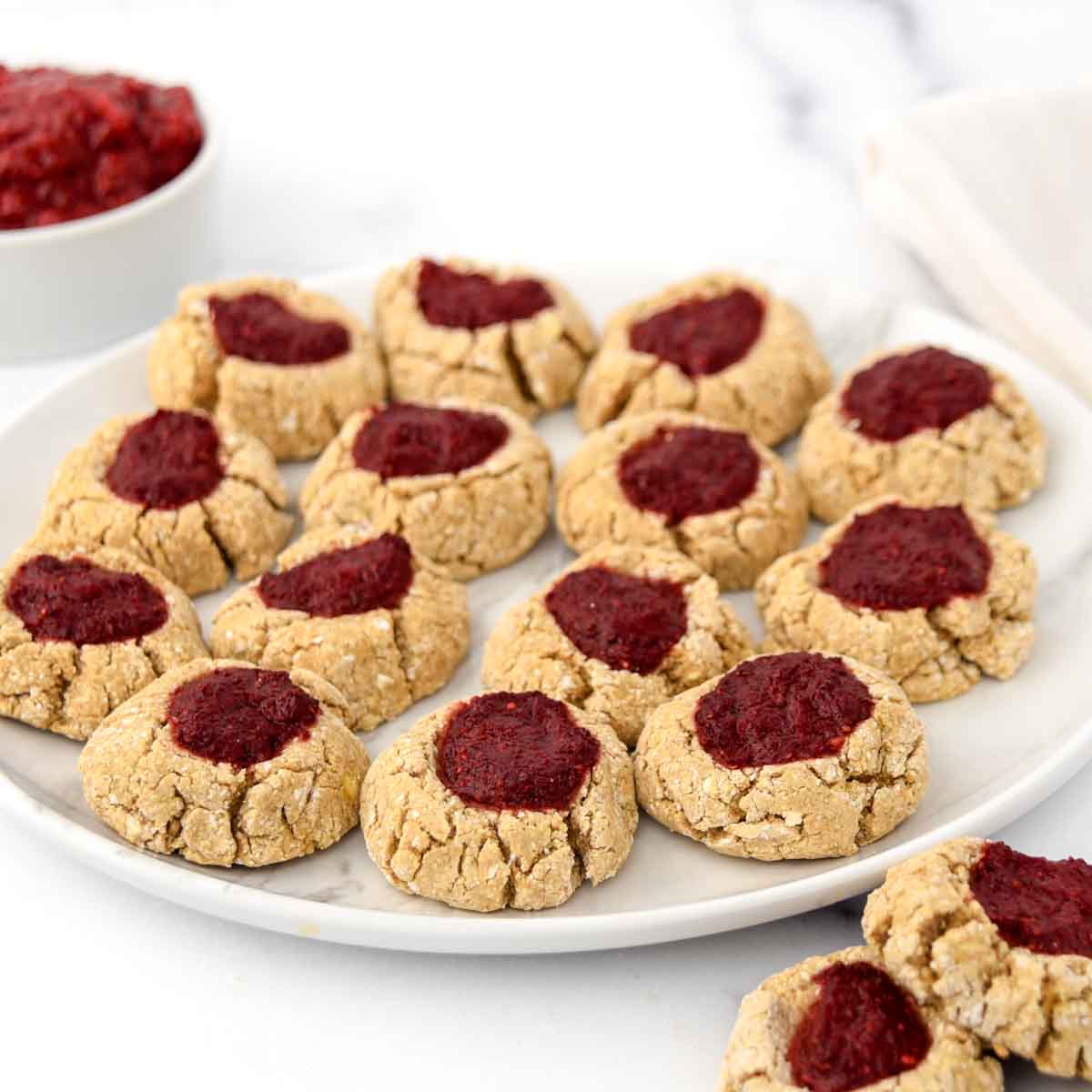 Homemade thumbprint cookies for dogs with strawberry jam filling.