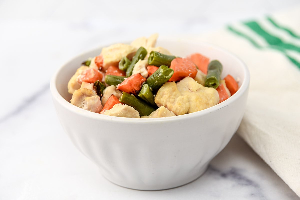 Air-fried chicken and veggie dog food in a small bowl.