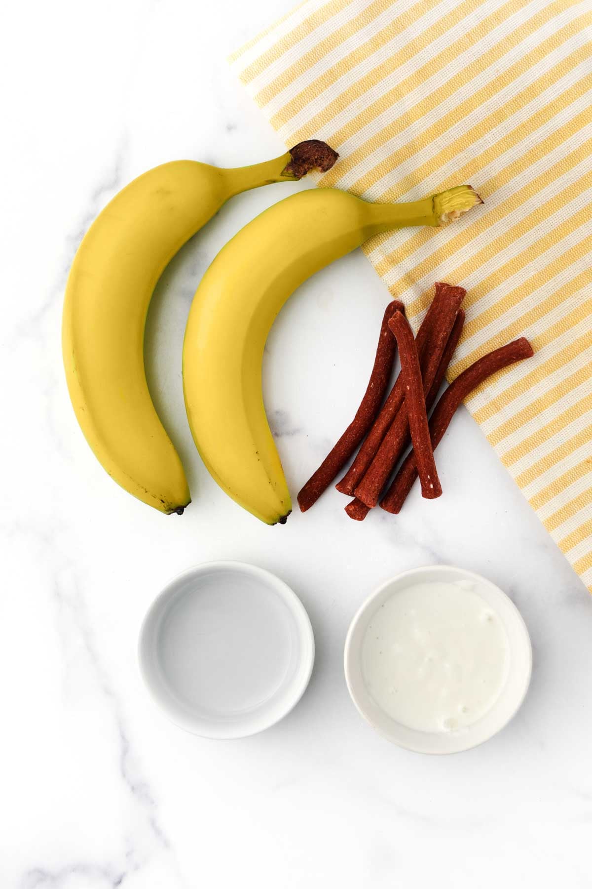 Bananas, Greek yogurt, water, and dog munchy sticks.