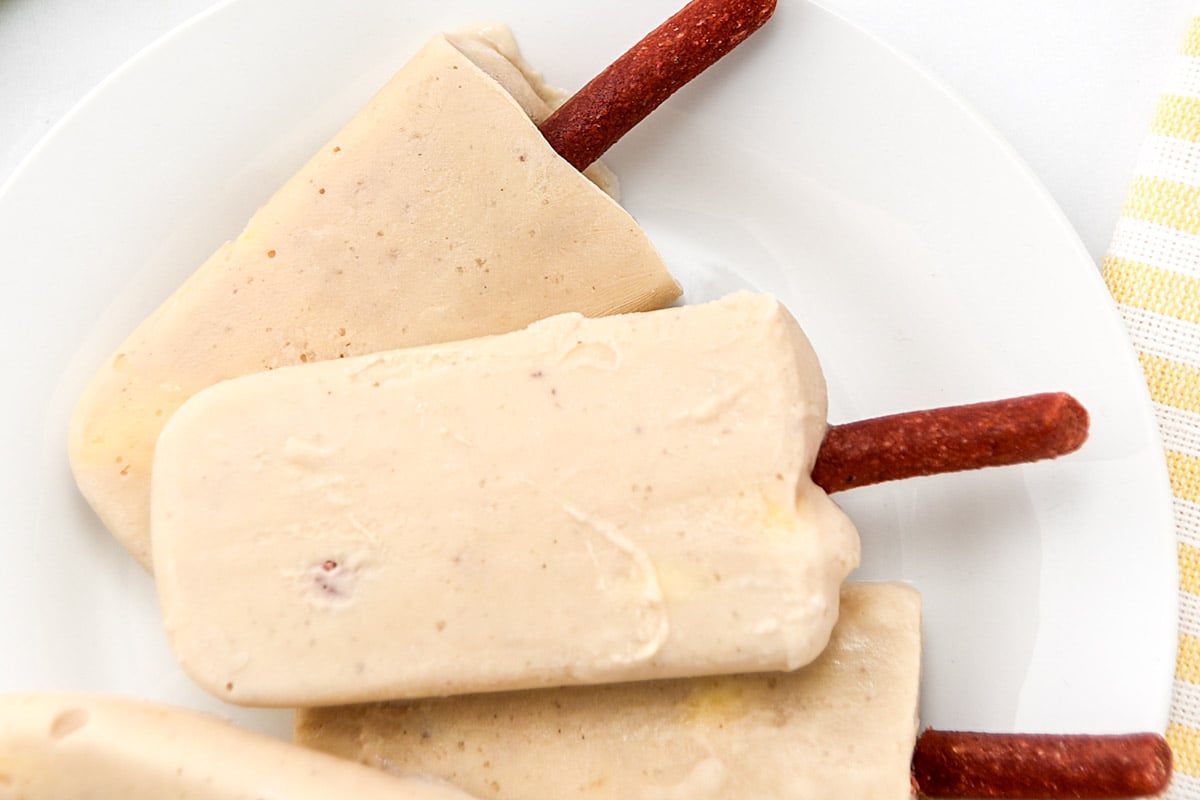 A plate of homemade banana popsicles for dogs.