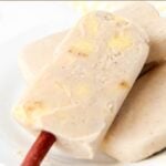 A banana popsicle with a dog munchy stick.