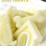 Frozen goat milk dog treats in various dog shapes on a plate.