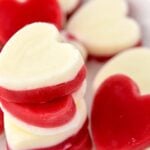 Heart-shaped frozen raspberry and yogurt layered dog treats.