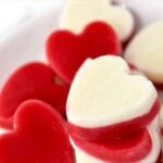 Frozen raspberry and yogurt layered dog treats in heart shapes.