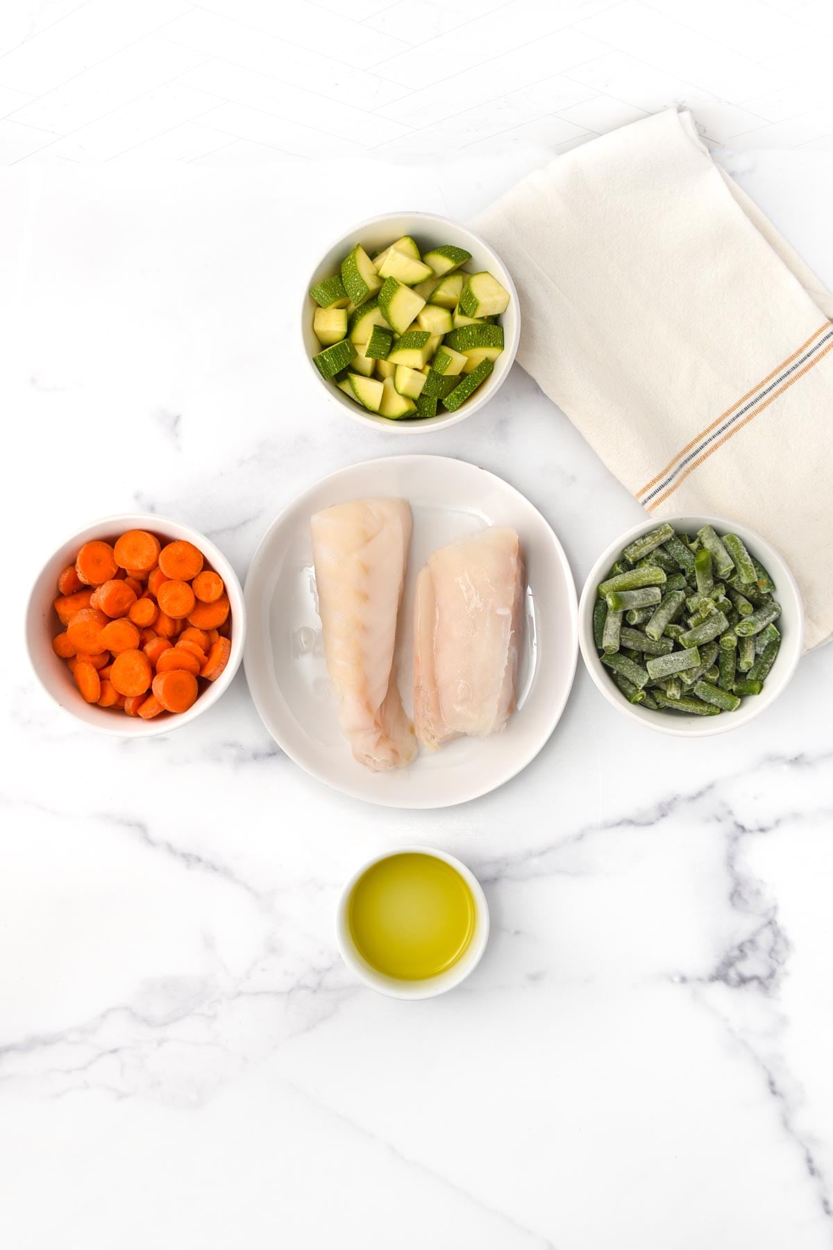 White fish, zucchini, carrots, green beans, and olive oil.