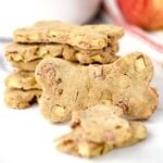 Homemade bone-shaped apple bacon dog treats.