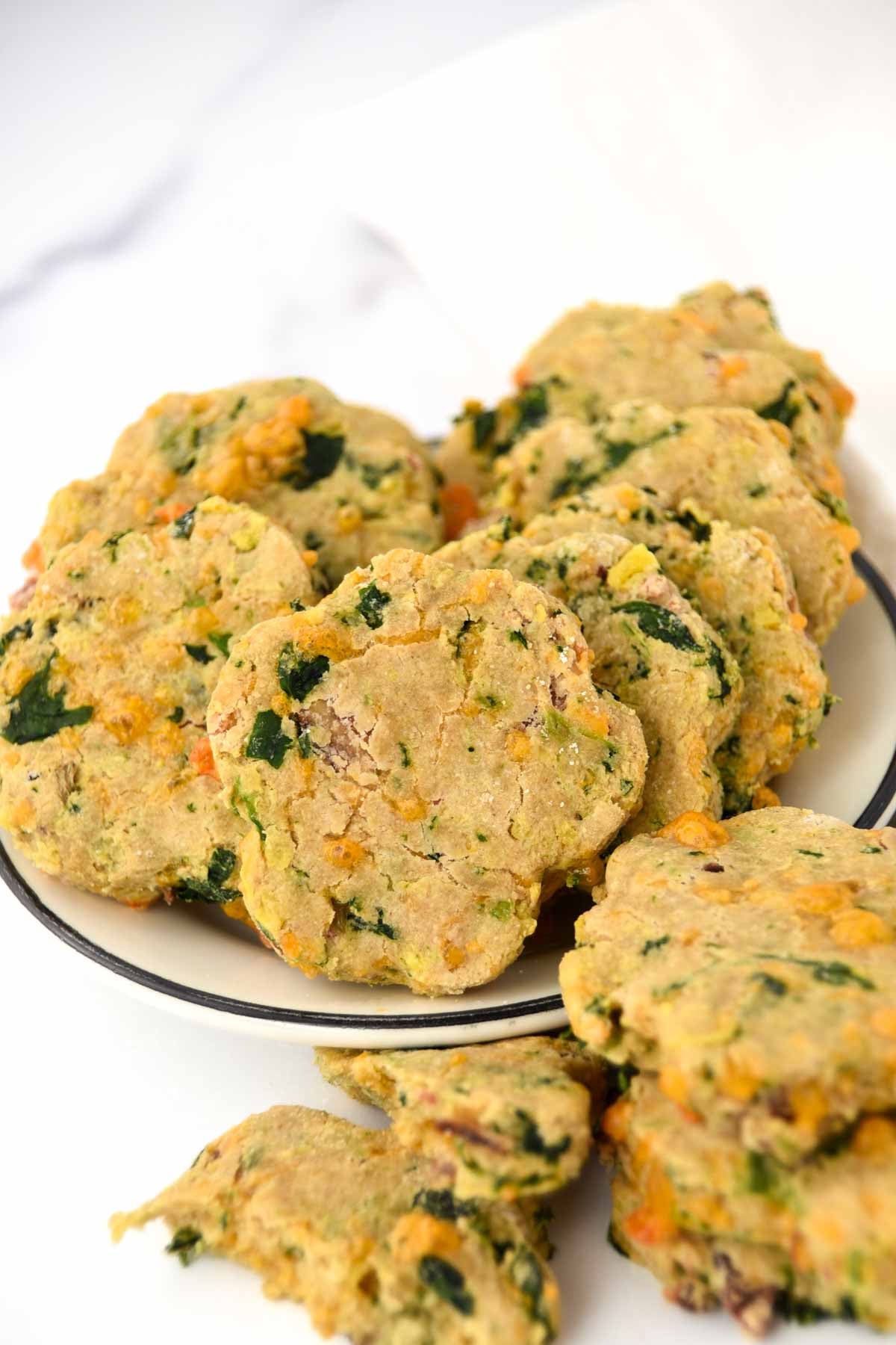 Homemade dog biscuits made with bacon, cheddar cheese, eggs, and spinach.