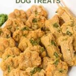A plate of homemade kale dog treats in paw and bone shapes.