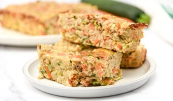 Slices of homemade chicken meatloaf for dogs made with zucchini, carrots, oats, and eggs.