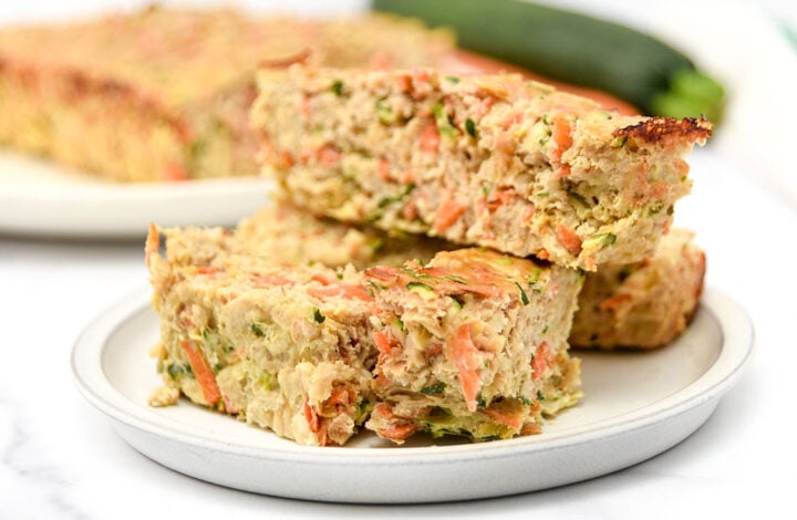 Slices of homemade chicken meatloaf for dogs made with zucchini, carrots, oats, and eggs.