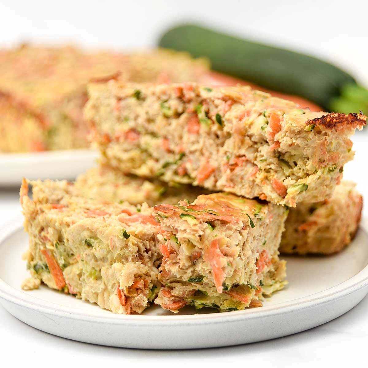 Homemade chicken meatloaf for dogs made with carrots, zucchini, oats, and eggs.