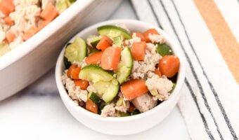 A bowl of baked ground chicken and veggies made for dogs.