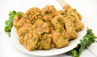 Homemade dog treats made with kale, sweet potato, and applesauce on a plate.