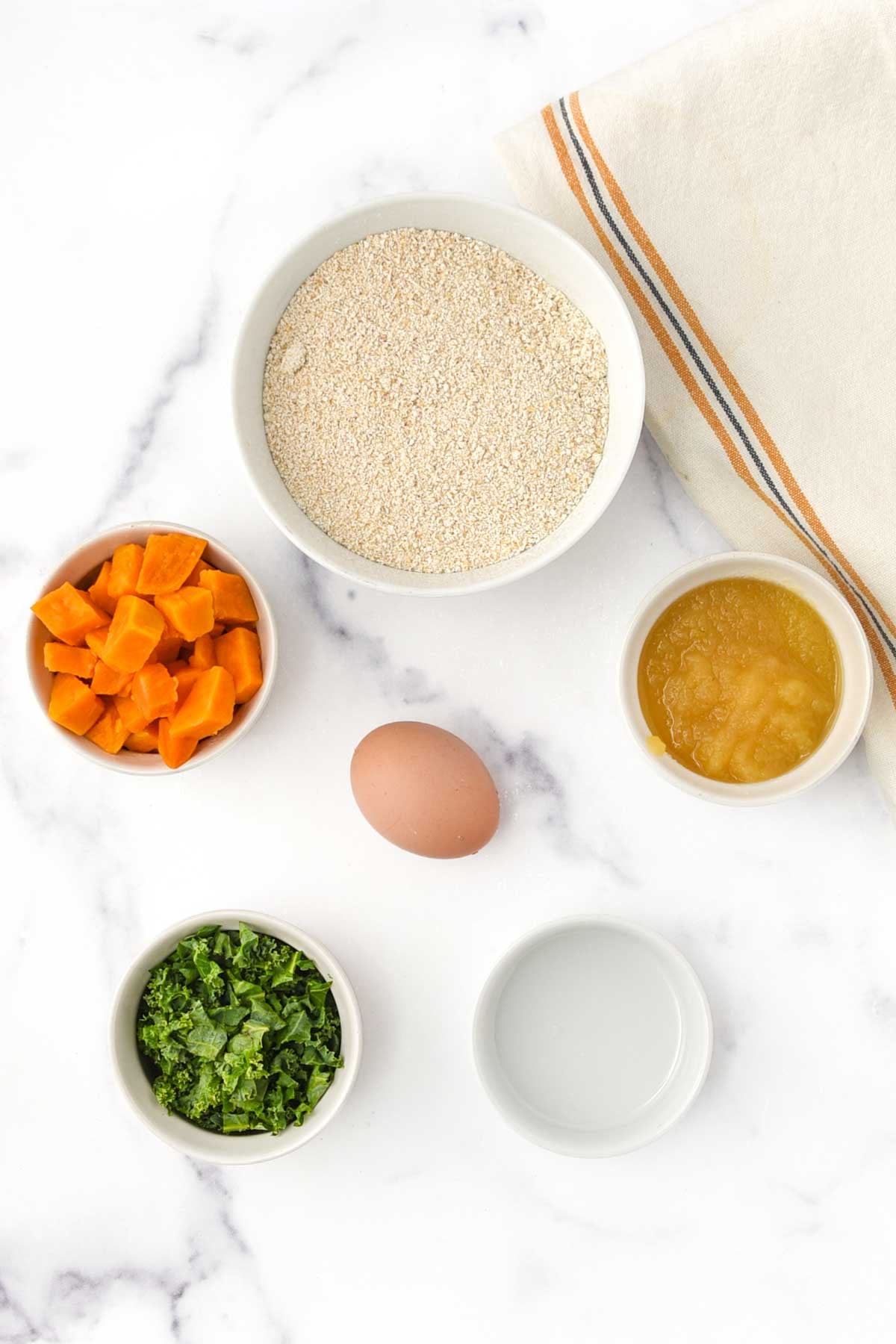 Kale, sweet potato, applesauce, egg, oat flour, and coconut oil.
