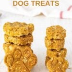 Stacks of homemade paw-shaped 3 ingredient dog treats.